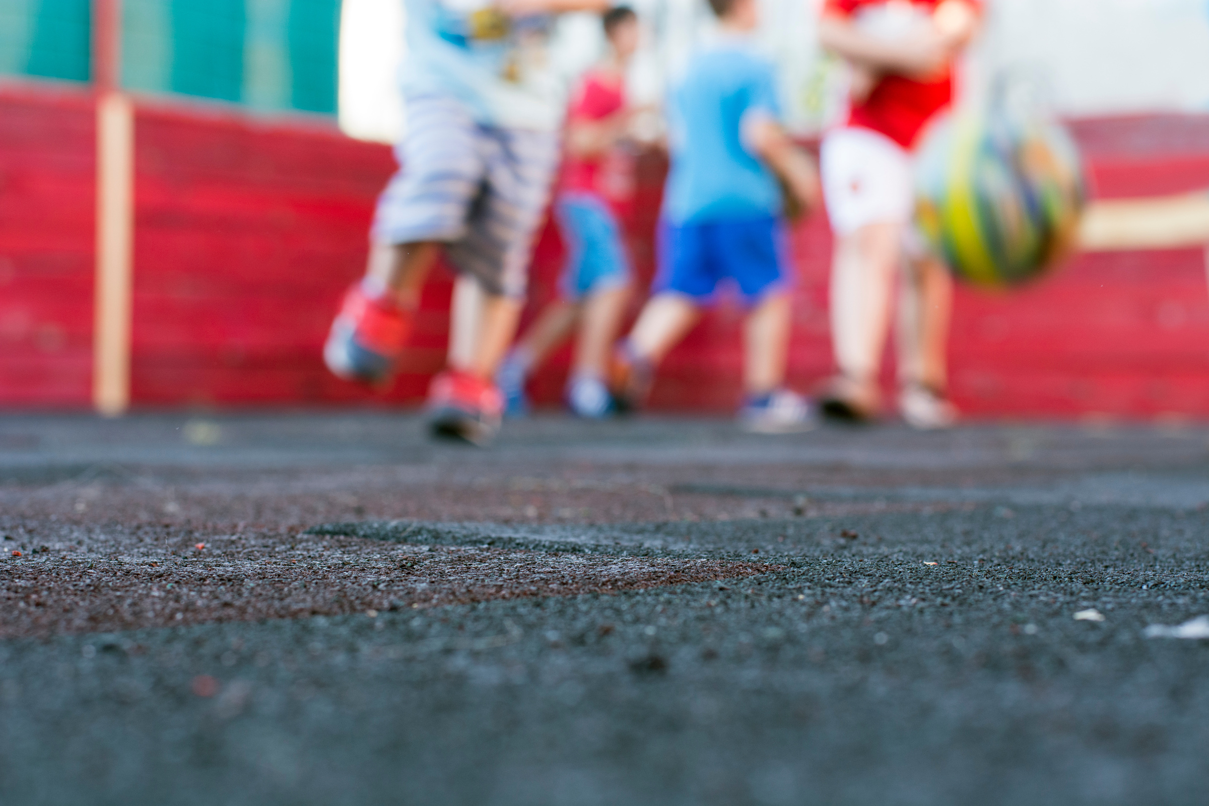 Kids playing football at school playground